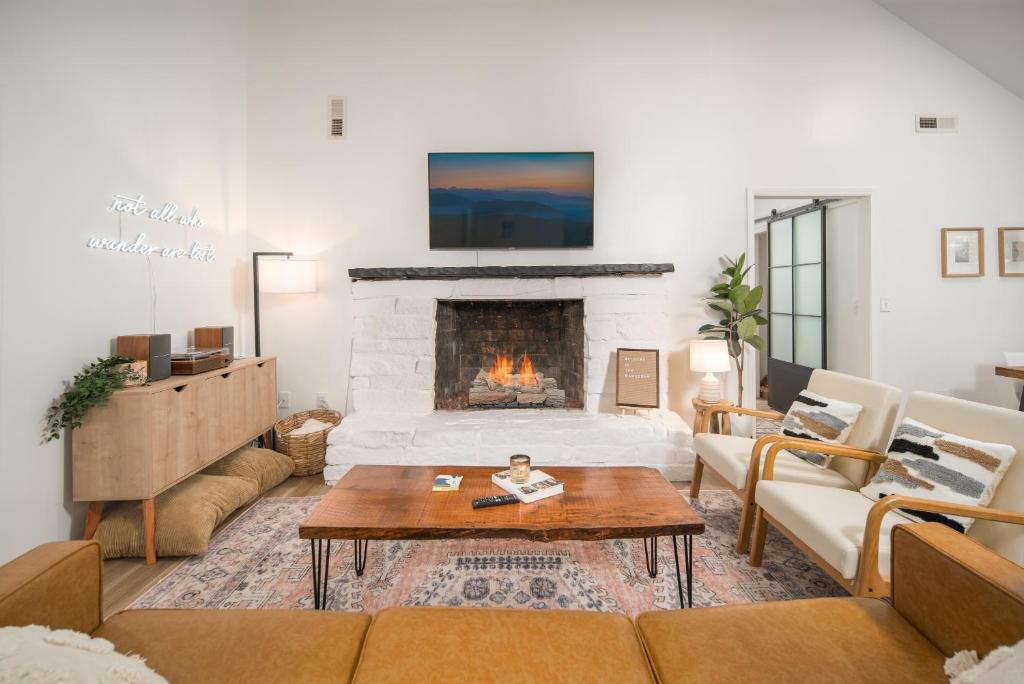 a living room with a couch and a fireplace at The Wanderer Guesthouse in Boone