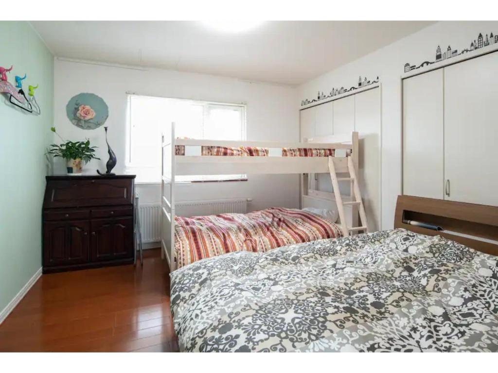 a bedroom with a bunk bed and a dresser at Art Salon Hosokawa - Vacation STAY 13628 in Sapporo