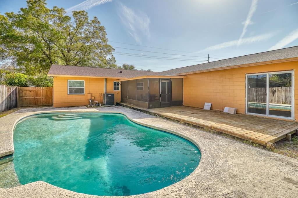a swimming pool in front of a house at Large Groups Up to 12 Guests In ground POOL in Tampa