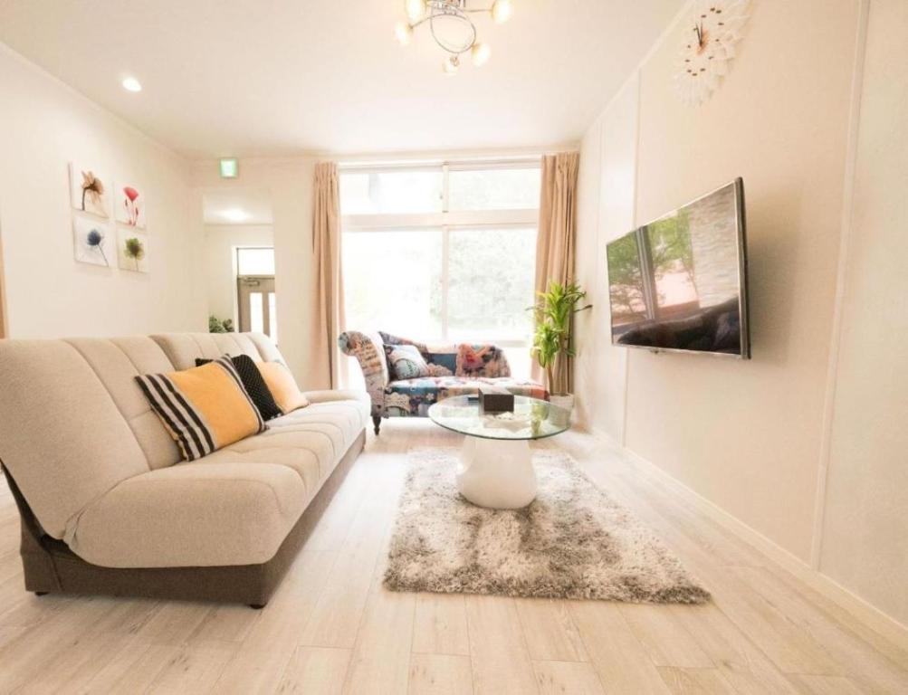 a living room with a couch and a table at Villa East Hana - Vacation STAY 76042v in Nago