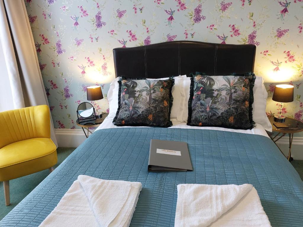 a bedroom with a bed with a book on it at The Patricia in Torquay