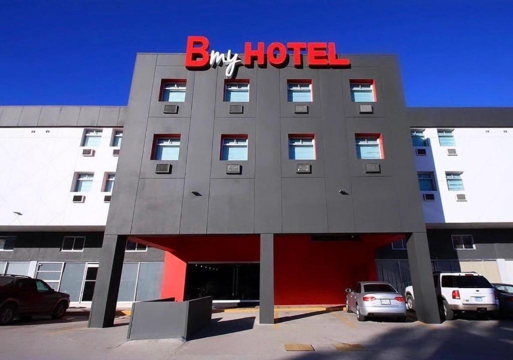a hotel with a red sign on the front of it at B my Hotel in Tijuana