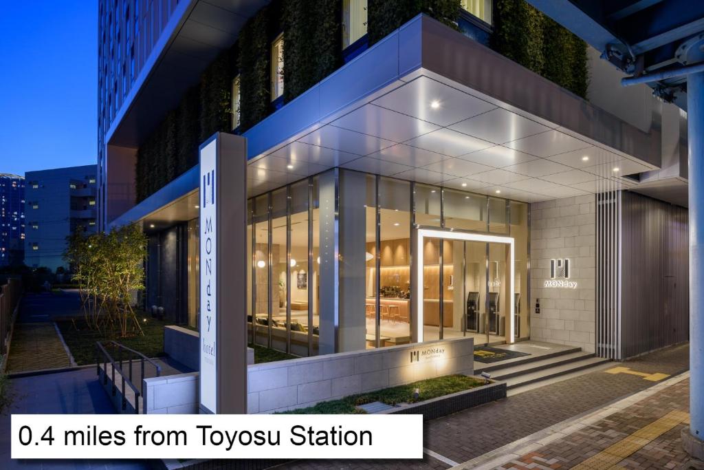 a building with glass windows and a sign that reads miles from tyson station at hotel MONday Premium TOYOSU in Tokyo