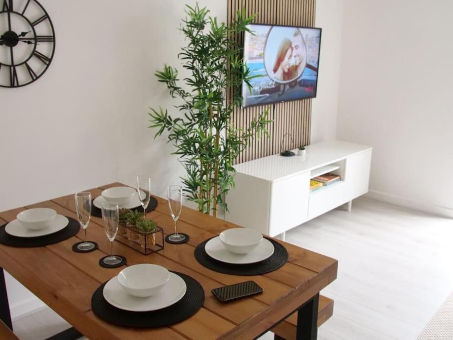 una mesa de comedor con platos blancos y negros. en Modern 2 Bed house - HS2, NEC & Birmingham Airport, en Marston Green