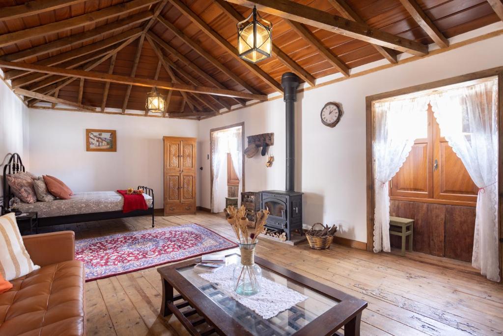 a living room with a couch and a fireplace at Casa SotoMayor in Santiago del Teide