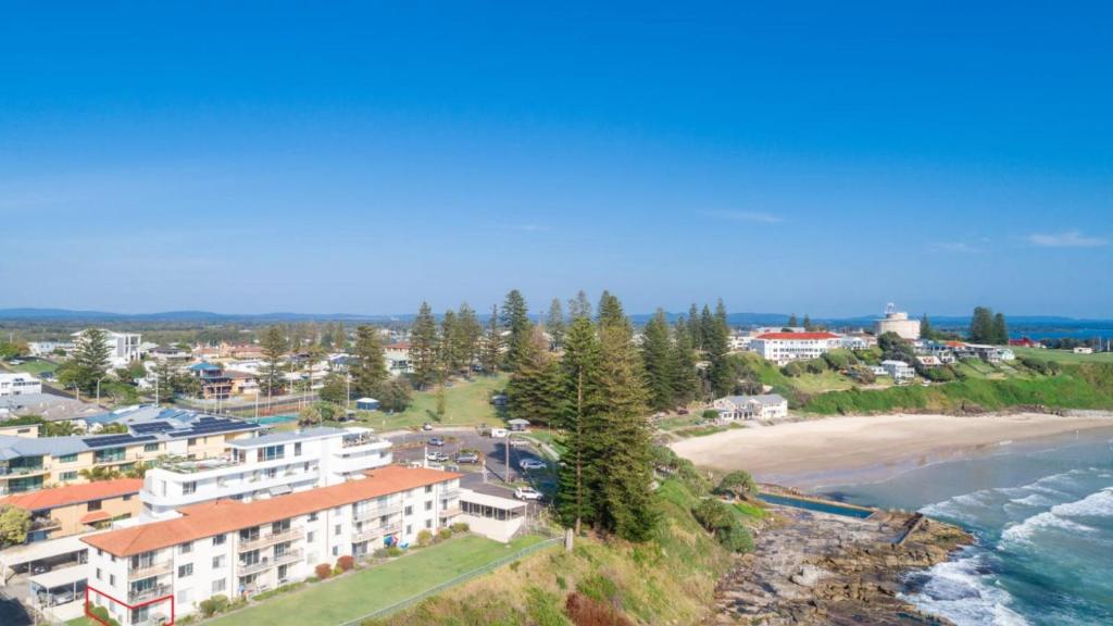 an aerial view of a beach and buildings at Craigmore on the Beach unit 6 in Yamba