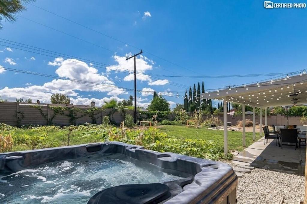 a hot tub in the backyard of a house at Beautiful 4 bd Mini-Farm Home in Simi with Hot Tub, One Full Bath and One Half Bath in Simi Valley