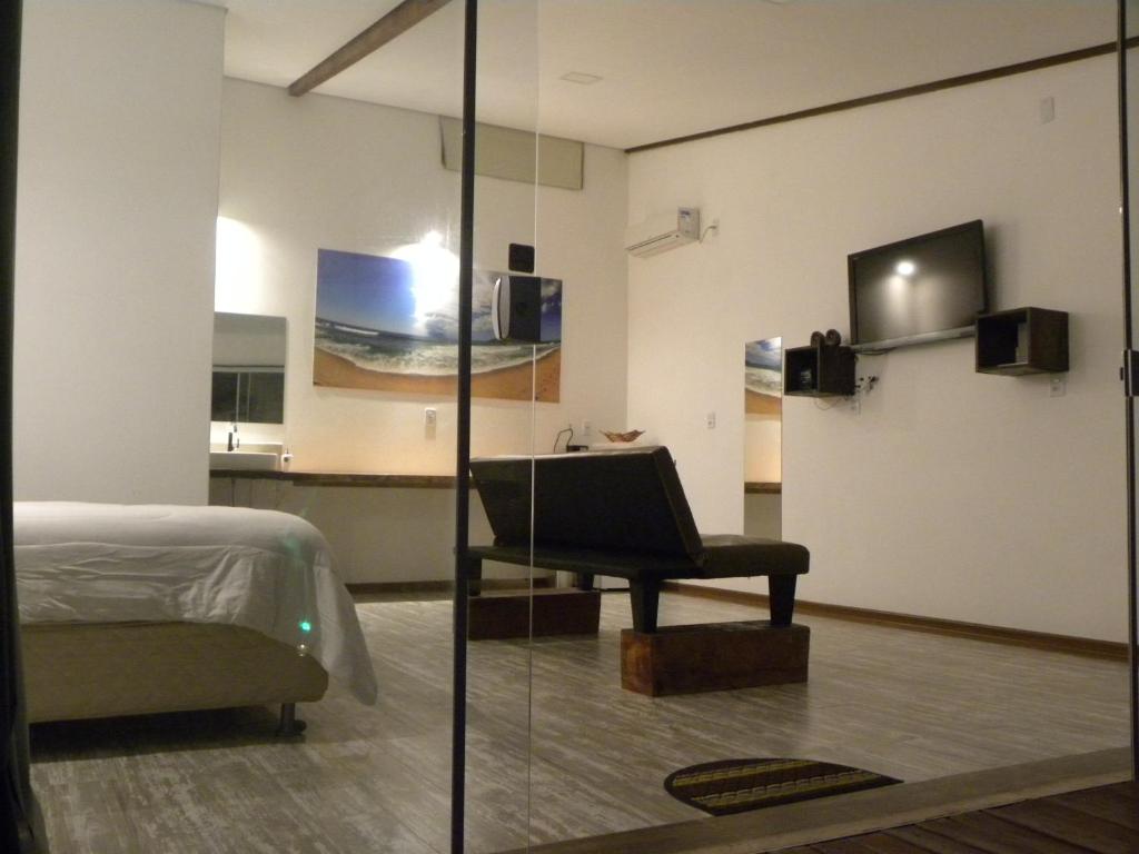 a bedroom with a bed and a piano in a room at Green Lodge Eco Life in Florianópolis