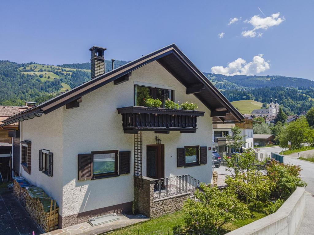 una casa con un balcón con flores. en Ferienhaus Rieder en Hopfgarten im Brixental