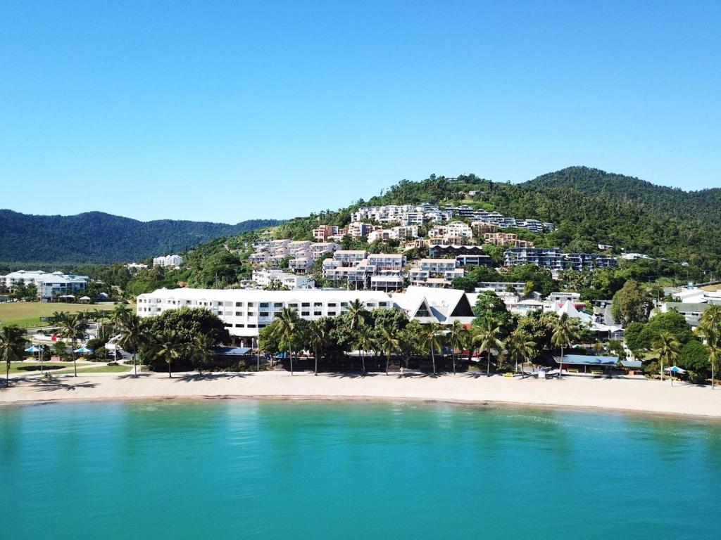 a view of a resort from the beach at Airlie Beach Hotel in Airlie Beach