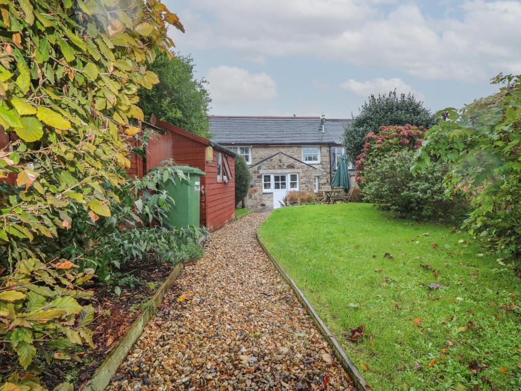 a house with a red fence and a yard at Trehan in St Ives
