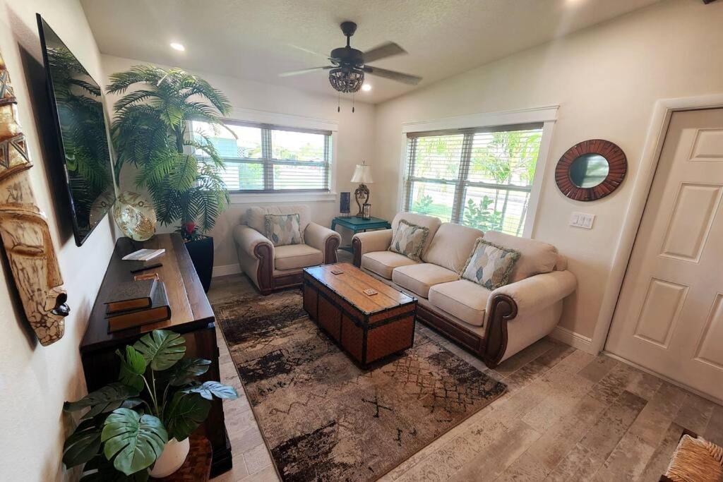 a living room with a couch and a table at Bali Bungalow - Downtown Cocoa Beach in Cocoa Beach