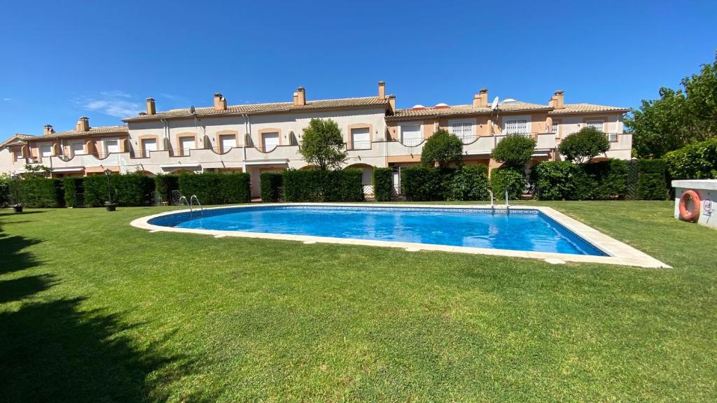 a large building with a swimming pool in a yard at Mar Blau Estartit Rental in L'Estartit