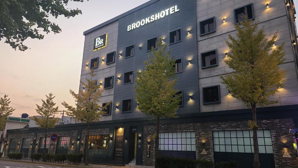 a building with a sign on the side of it at Brooks Hotel Tongyeong in Tongyeong