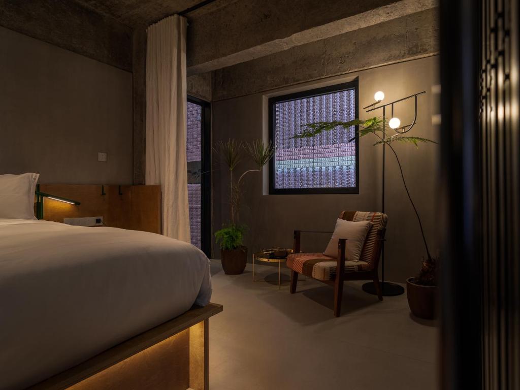 Postel nebo postele na pokoji v ubytování Jiangnan House Nantou