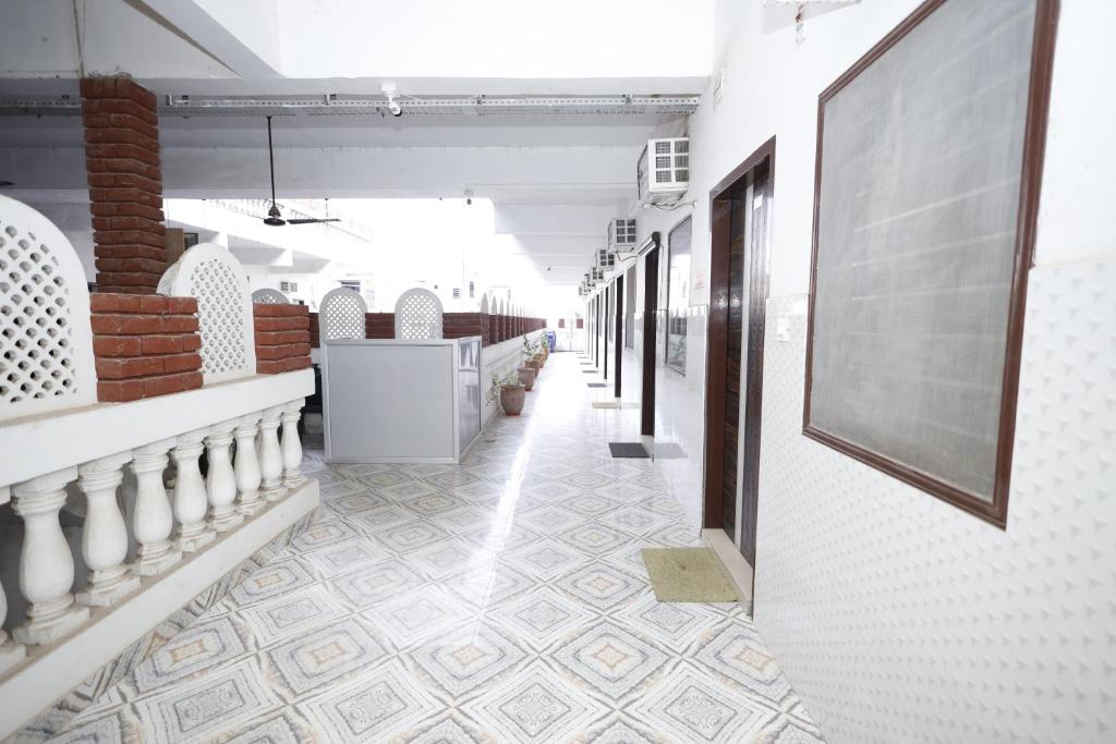a hallway of a store with a tile floor and a wall at HOTEL K FORT in Jalandhar