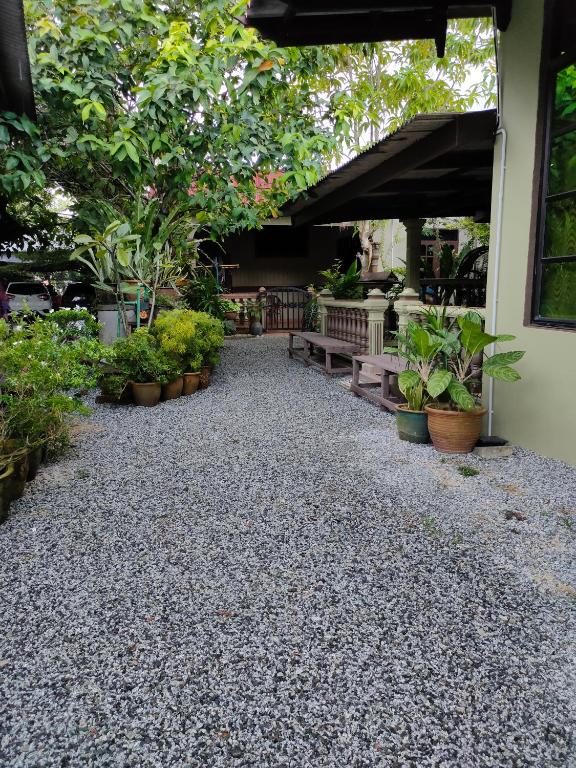a patio with plants and a bunch of benches at Hidden Homestay in Marang