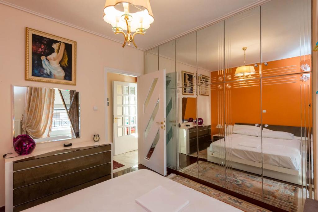 a bedroom with a bed and a glass wall at Flisvos Elite Seafront Luxury Apartment in Athens