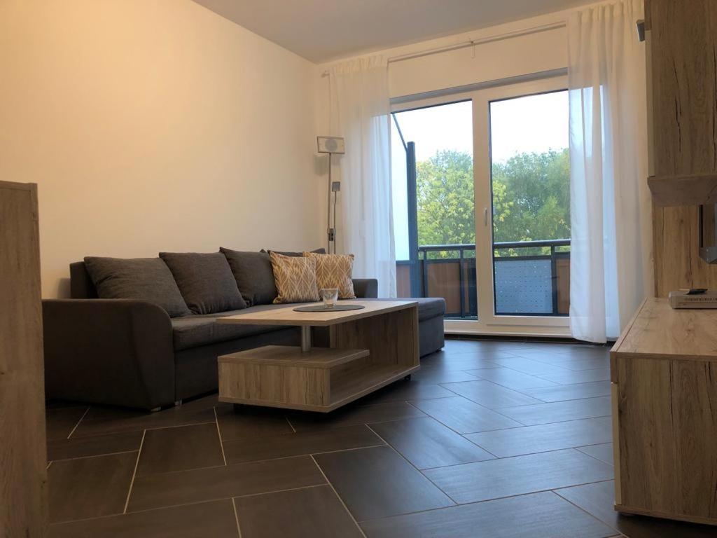 a living room with a couch and a coffee table at Gästewohnung 6 in Oschersleben