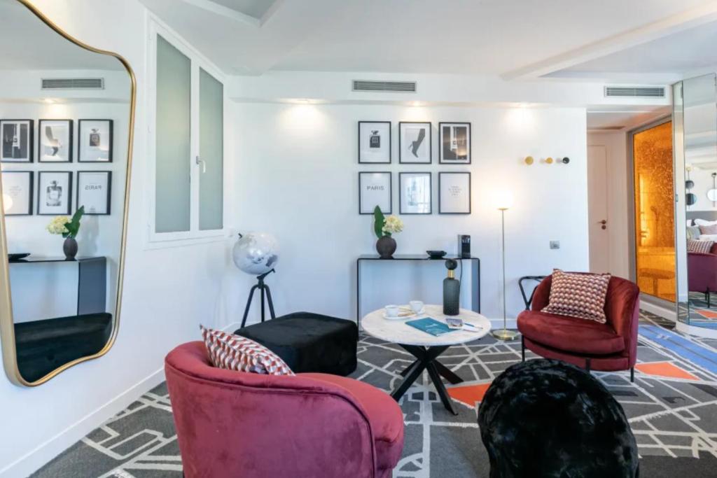 a living room with two chairs and a table at Sublim by Sweet Inn in Paris