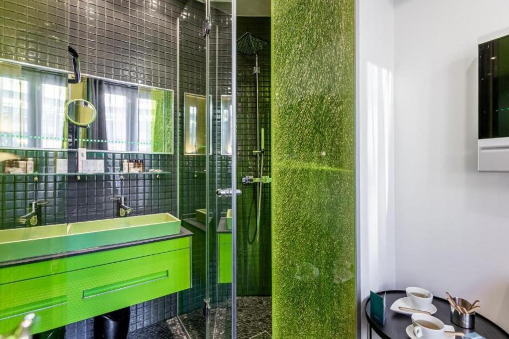 a bathroom with a green sink and a shower at Sublim by Sweet Inn in Paris