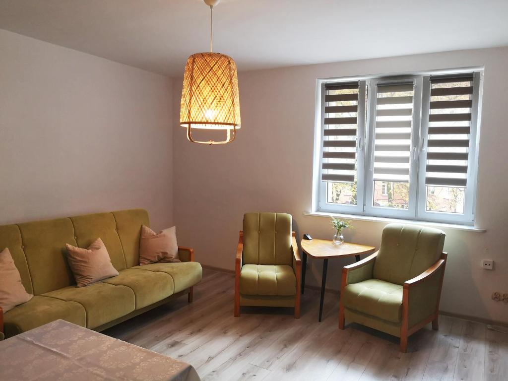 a living room with a couch and a table at Apartament śródmiejski in Gdańsk