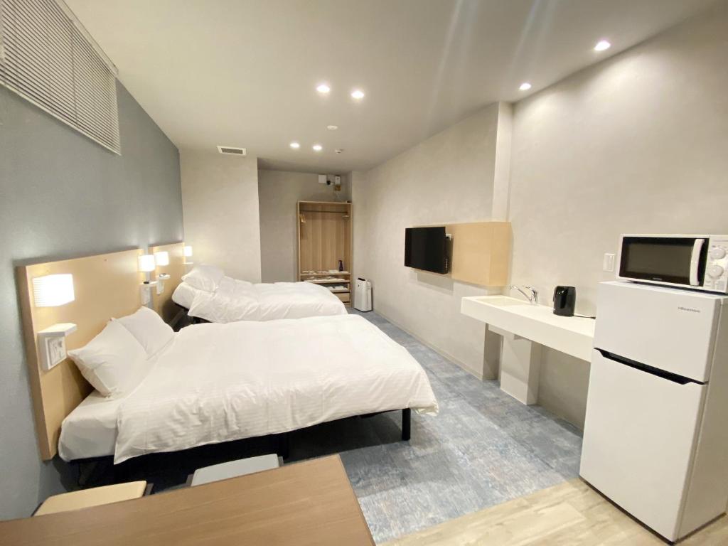Postel nebo postele na pokoji v ubytování Takanobashi HOTEL
