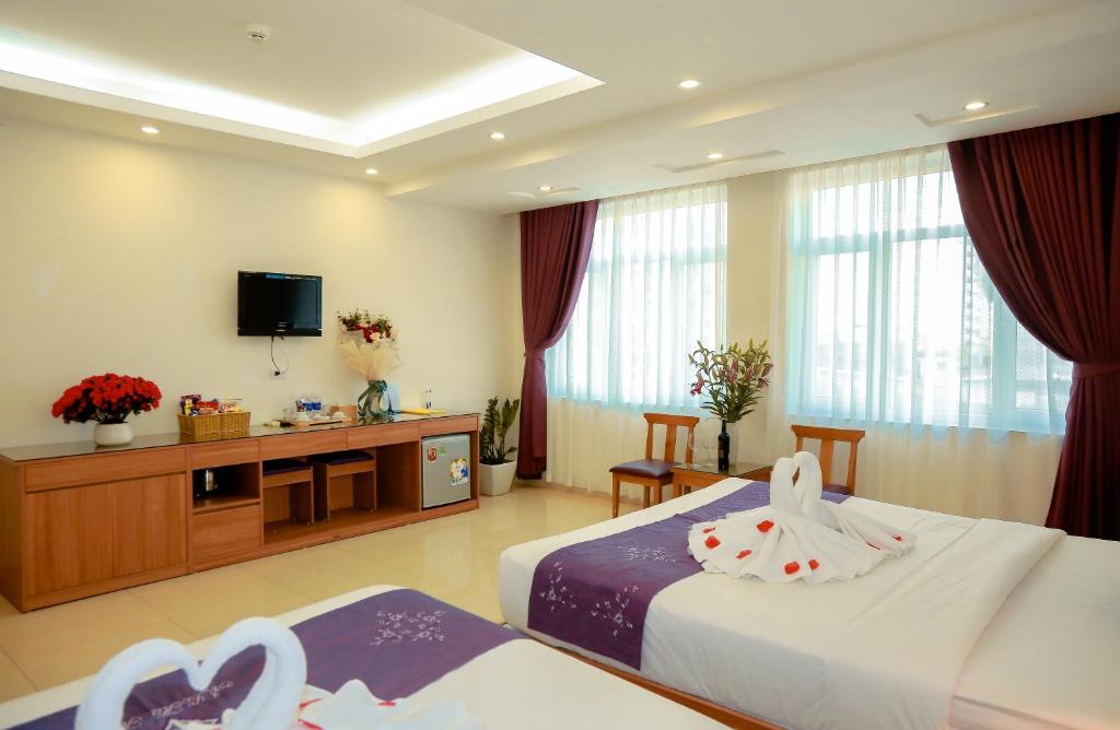 Postel nebo postele na pokoji v ubytování Aloha Hotel