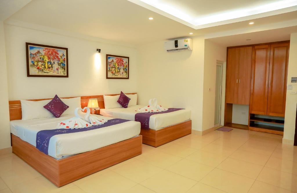 Postel nebo postele na pokoji v ubytování Aloha Hotel