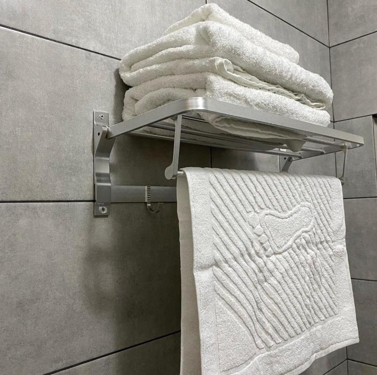 a towel rack with towels on it in a bathroom at Sapphire hotels in Taraz