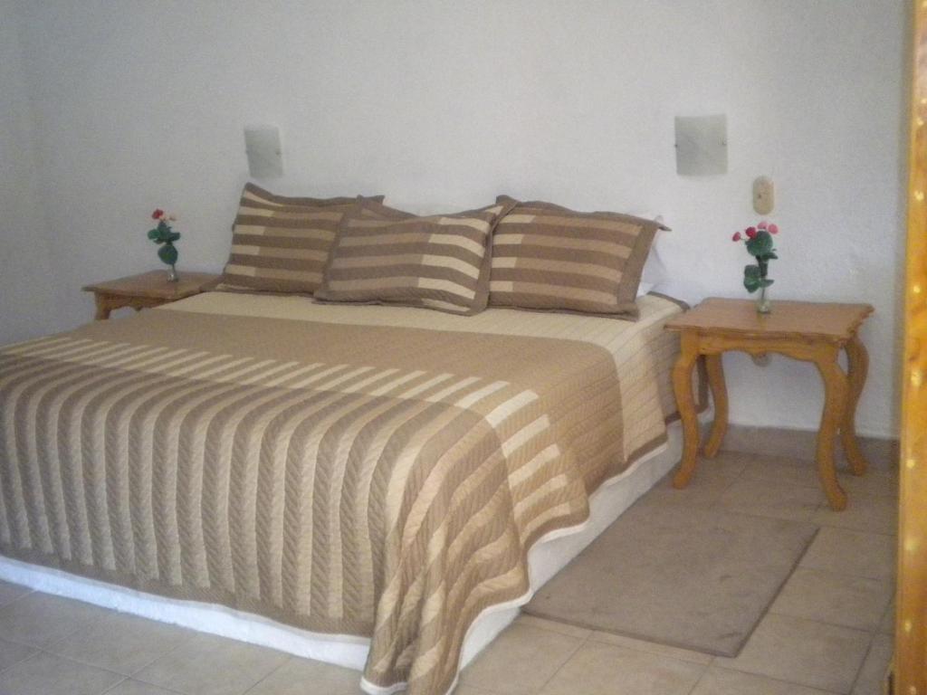 Postel nebo postele na pokoji v ubytování Hotel Ollin Teotl