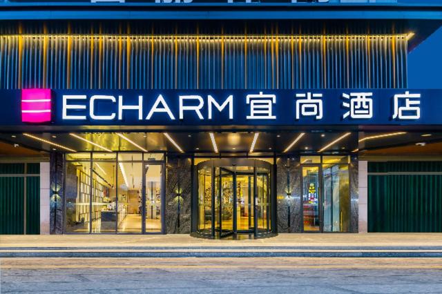 a store front of a building with a sign on it at Echarm Hotel Foshan Guangfo Road Jiaokou Metro Station in Foshan