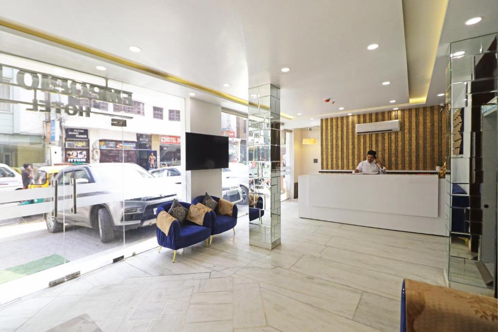 a lobby of a store with a man behind a counter at Hotel Emporio Dx - New Delhi Railway Station - Paharganj in New Delhi