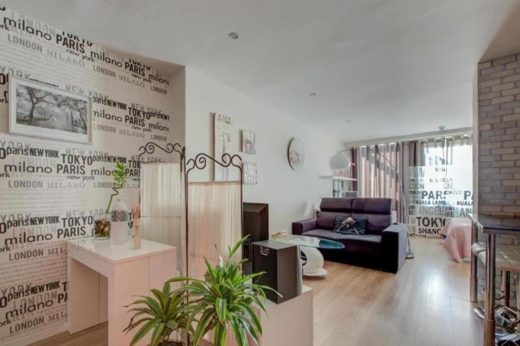 a living room with a couch and a chair at Apartamento loft en plaza España - gran vía in Madrid