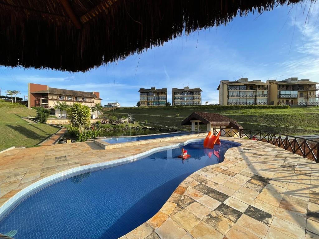 a swimming pool in a resort with buildings in the background at Sonhos da Serra bananeiras in Bananeiras