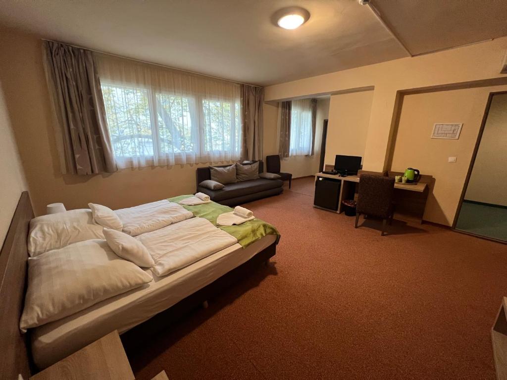 sypialnia z łóżkiem i biurkiem w pokoju w obiekcie Centrooms Eger w Egerze