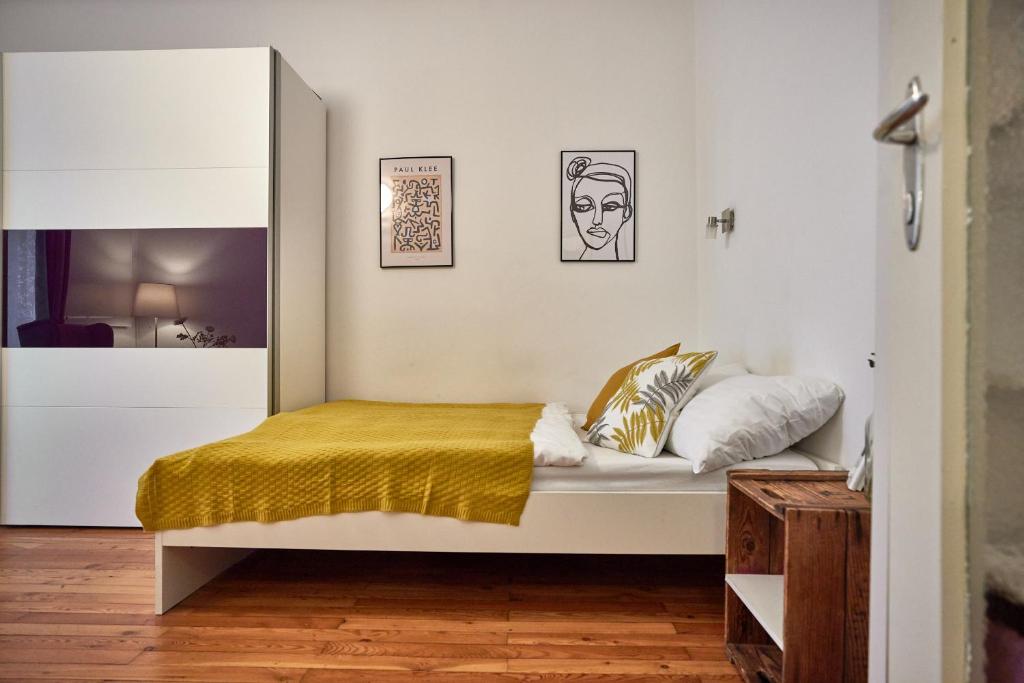 a bedroom with a bed with a yellow blanket at Cosy & Charming In The City Centre in Vienna