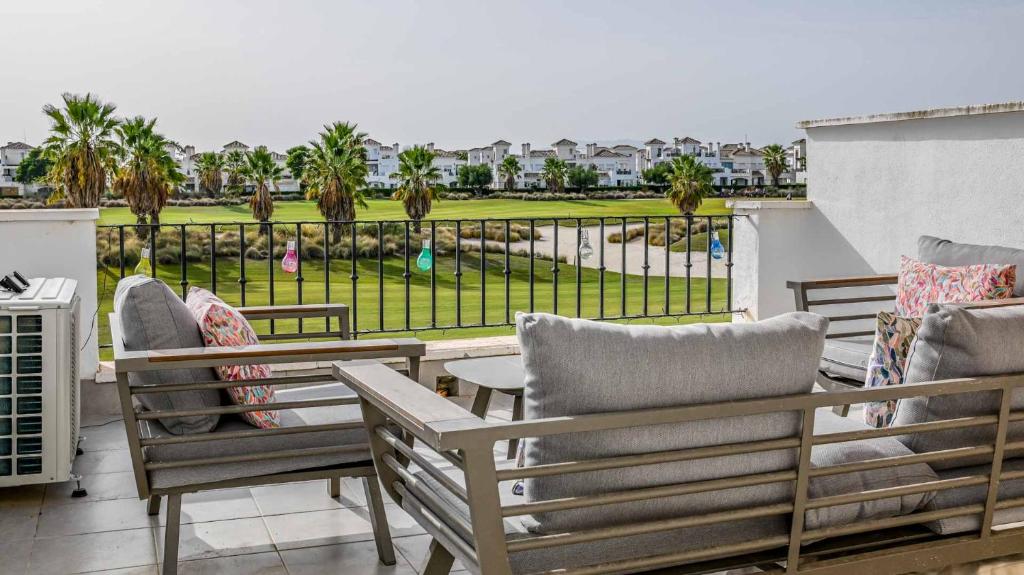 a balcony with chairs and a view of a park at Modern Stunning Townhouse 3 bed 2 bath on La Torre CE51LT in Torre-Pacheco