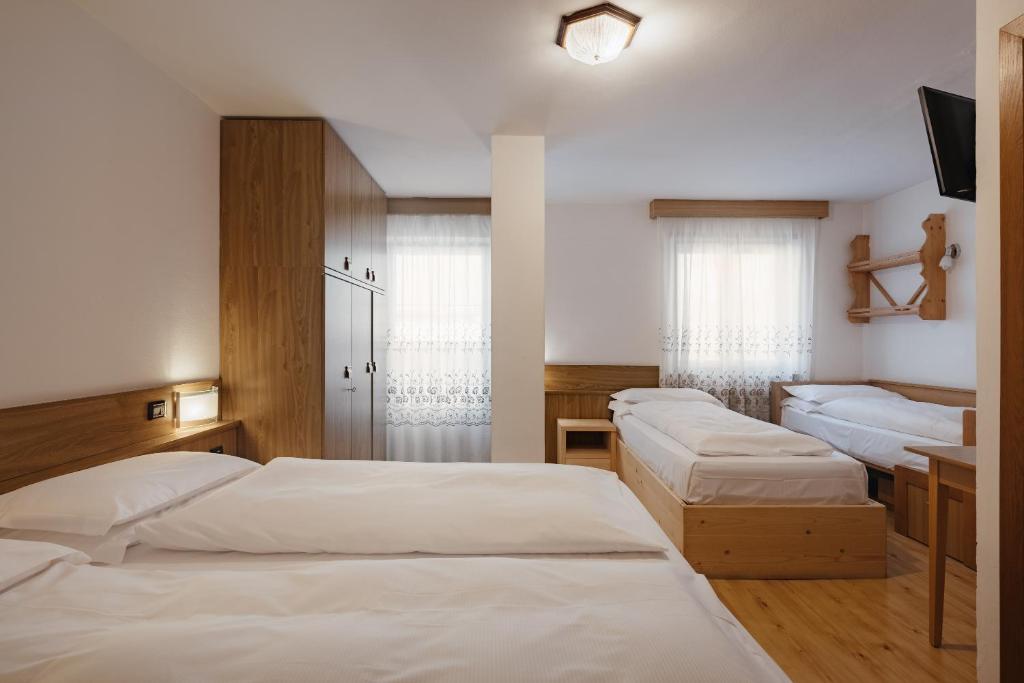 Postel nebo postele na pokoji v ubytování Hotel La Montanara Predazzo