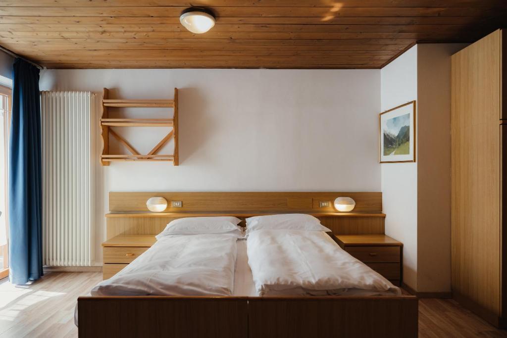 Postel nebo postele na pokoji v ubytování Hotel La Montanara Predazzo