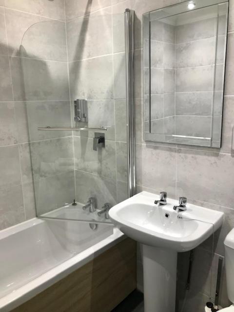 a bathroom with a sink and a shower and a tub at Lunan House in Arbroath