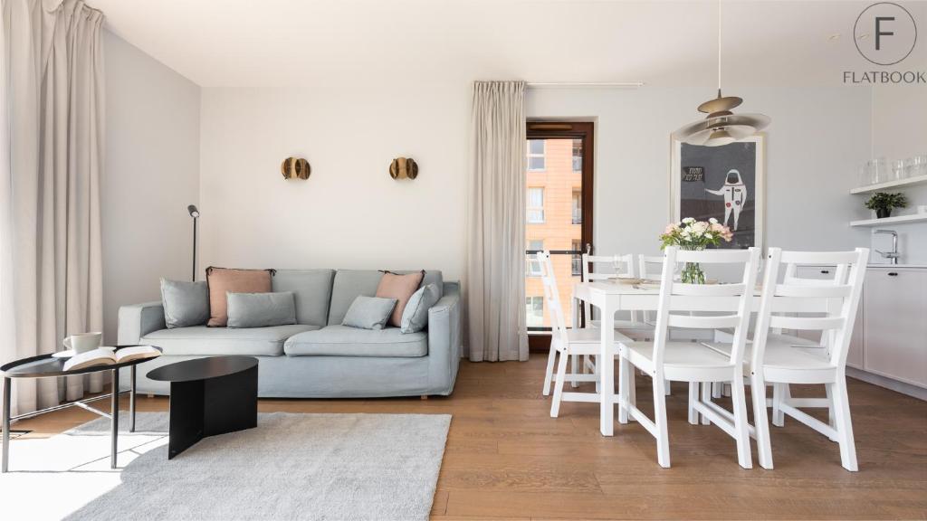 a living room with a couch and a table at Flatbook - City Center SPA Apartments Motlawa in Gdańsk