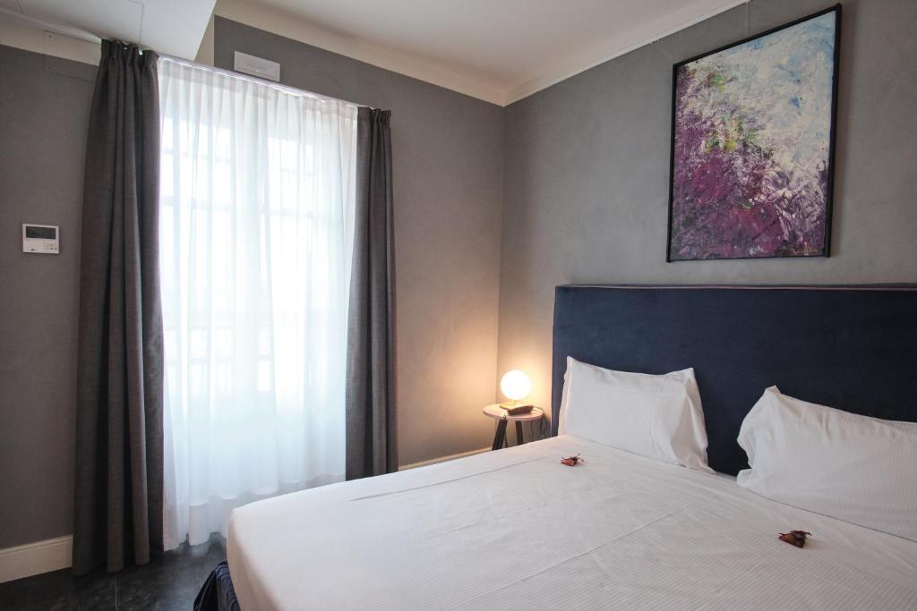 Postel nebo postele na pokoji v ubytování Capriccio Art Hotel