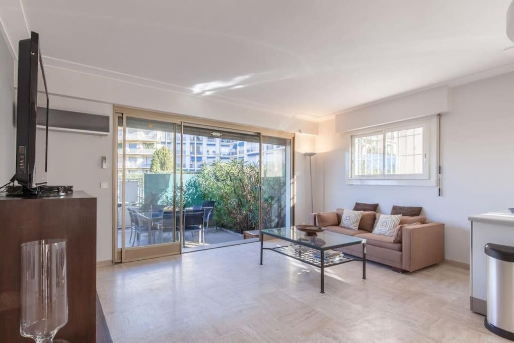 a living room with a couch and a table at Chic and modern apt with terrace - La Croisette in Cannes