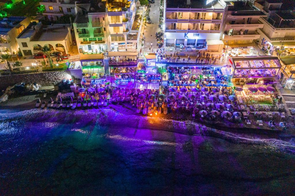 an aerial view of a nightclub at night at Kahlua Sea View Suites in Hersonissos