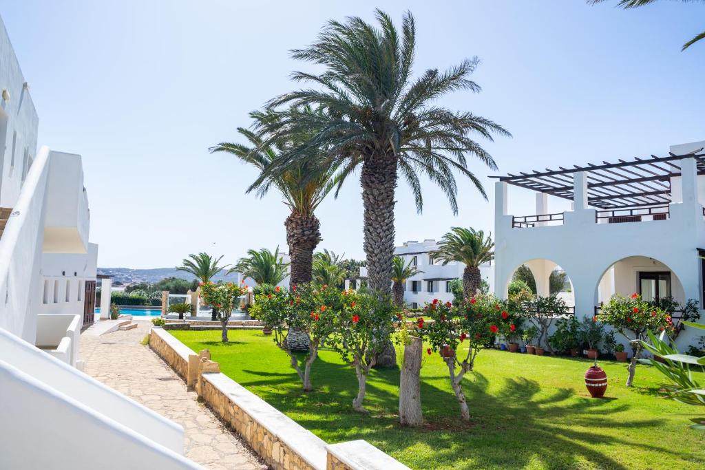 a view from the balcony of a house with palm trees at Irini Hotel in Afiartis