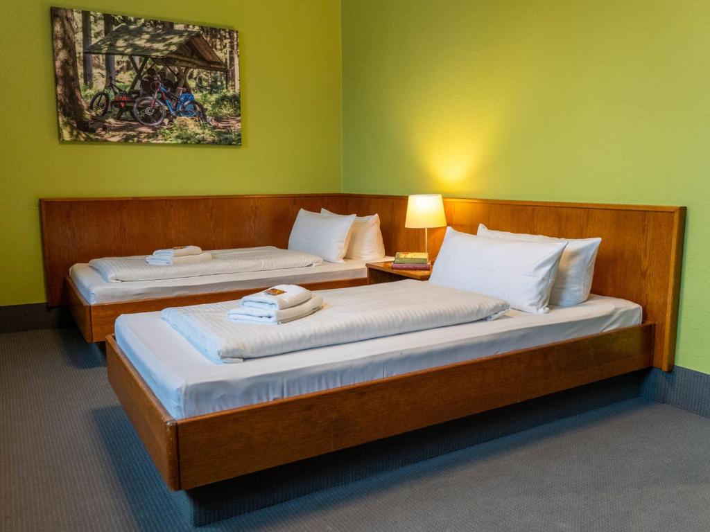 Postel nebo postele na pokoji v ubytování k1 sporthotel - Bike & Ski inklusive Hotel