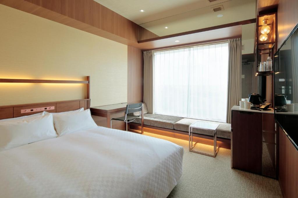 Postel nebo postele na pokoji v ubytování Candeo Hotel Utsunomiya