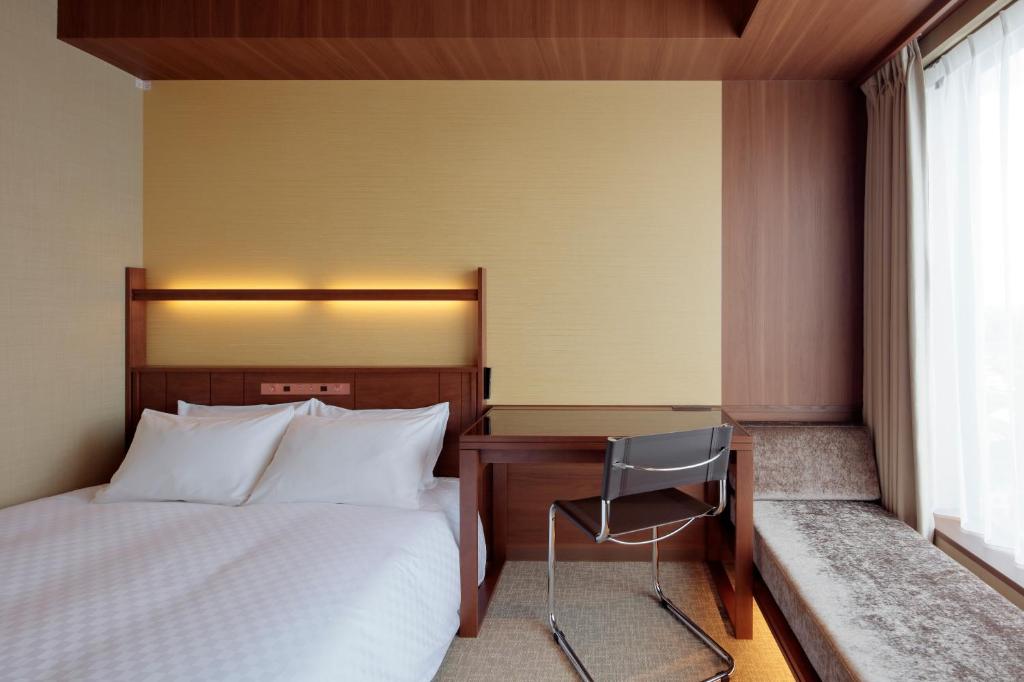 Postel nebo postele na pokoji v ubytování Candeo Hotel Utsunomiya
