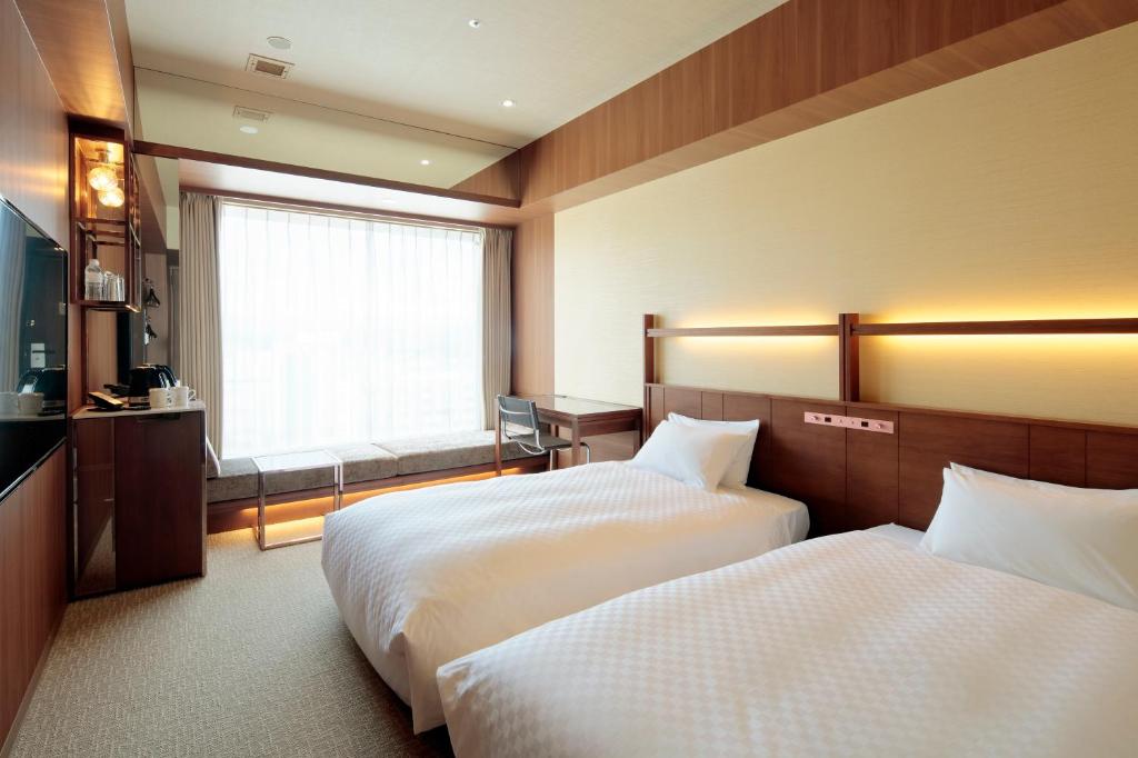 Postel nebo postele na pokoji v ubytování Candeo Hotel Utsunomiya
